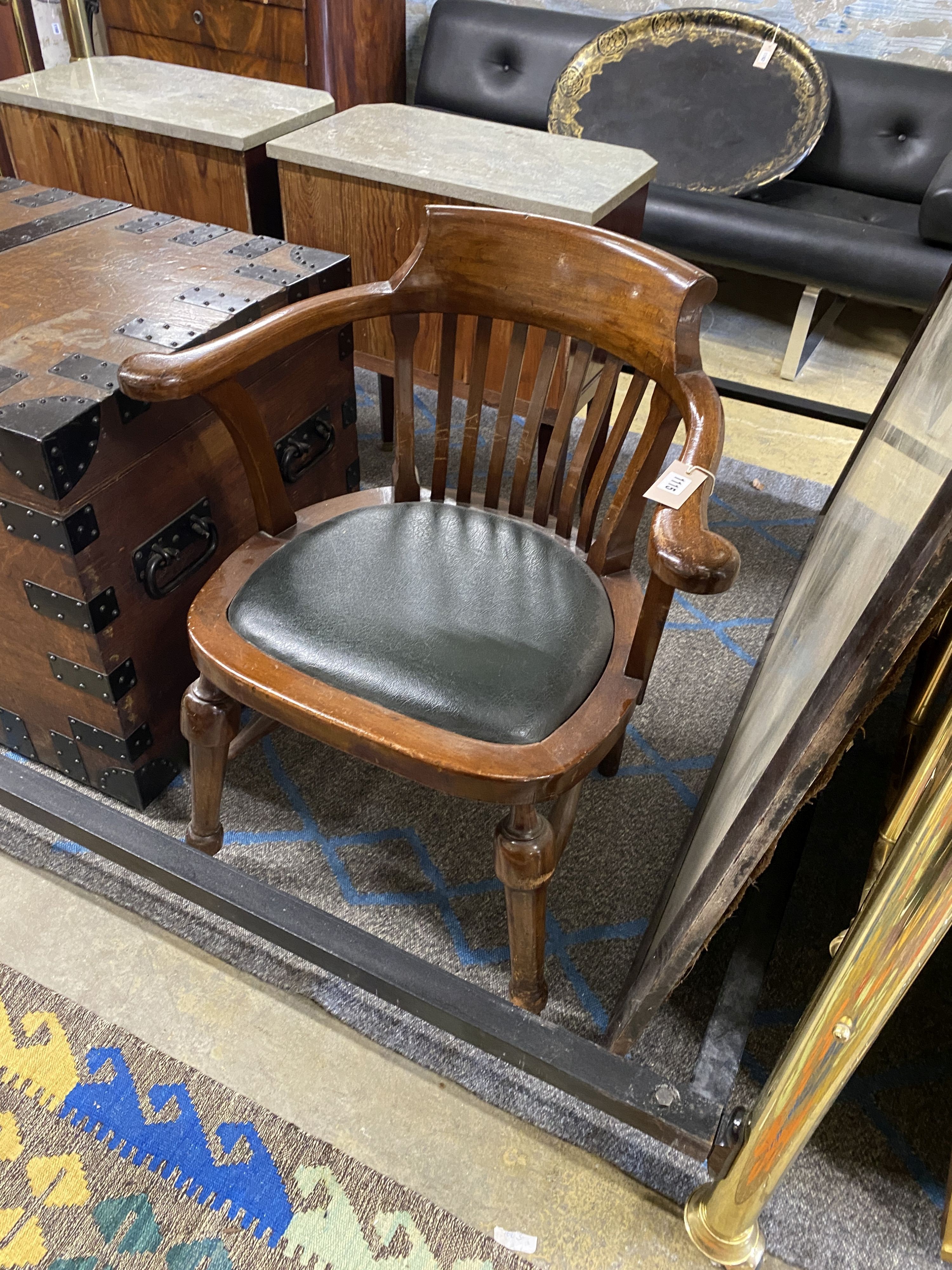 An early 20th century mahogany desk elbow chair